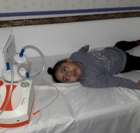 PCRF Provide Suction Machine to Child in Gaza