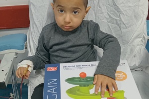 Child Receiving an Educational Toy During Treatment