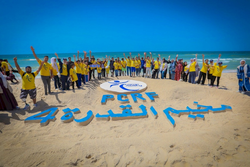 Artistic Unity on Gaza's Shore: Amputees Create Emblem of Connection at Camp Ability